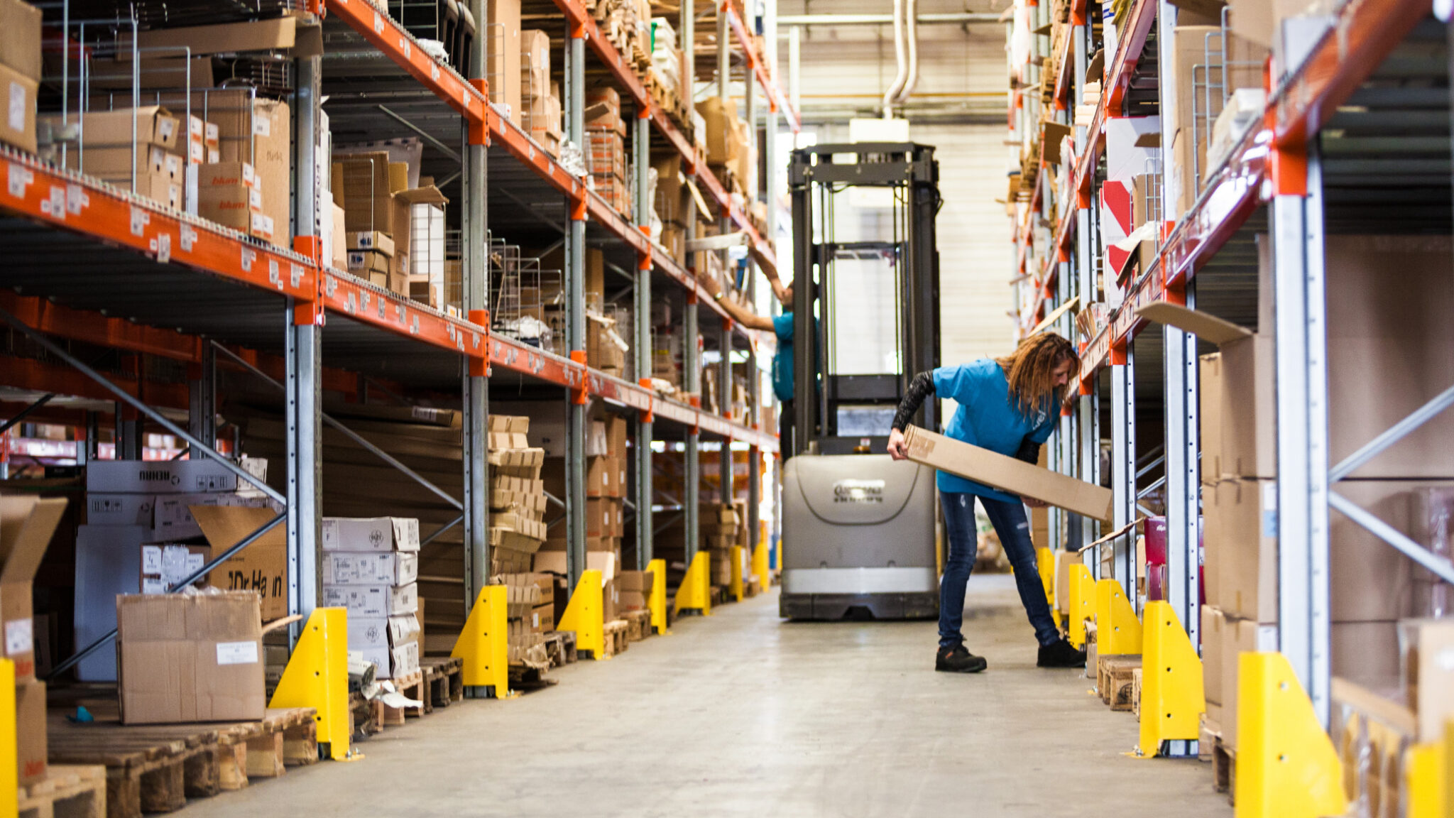 Woman stocking warehouse
