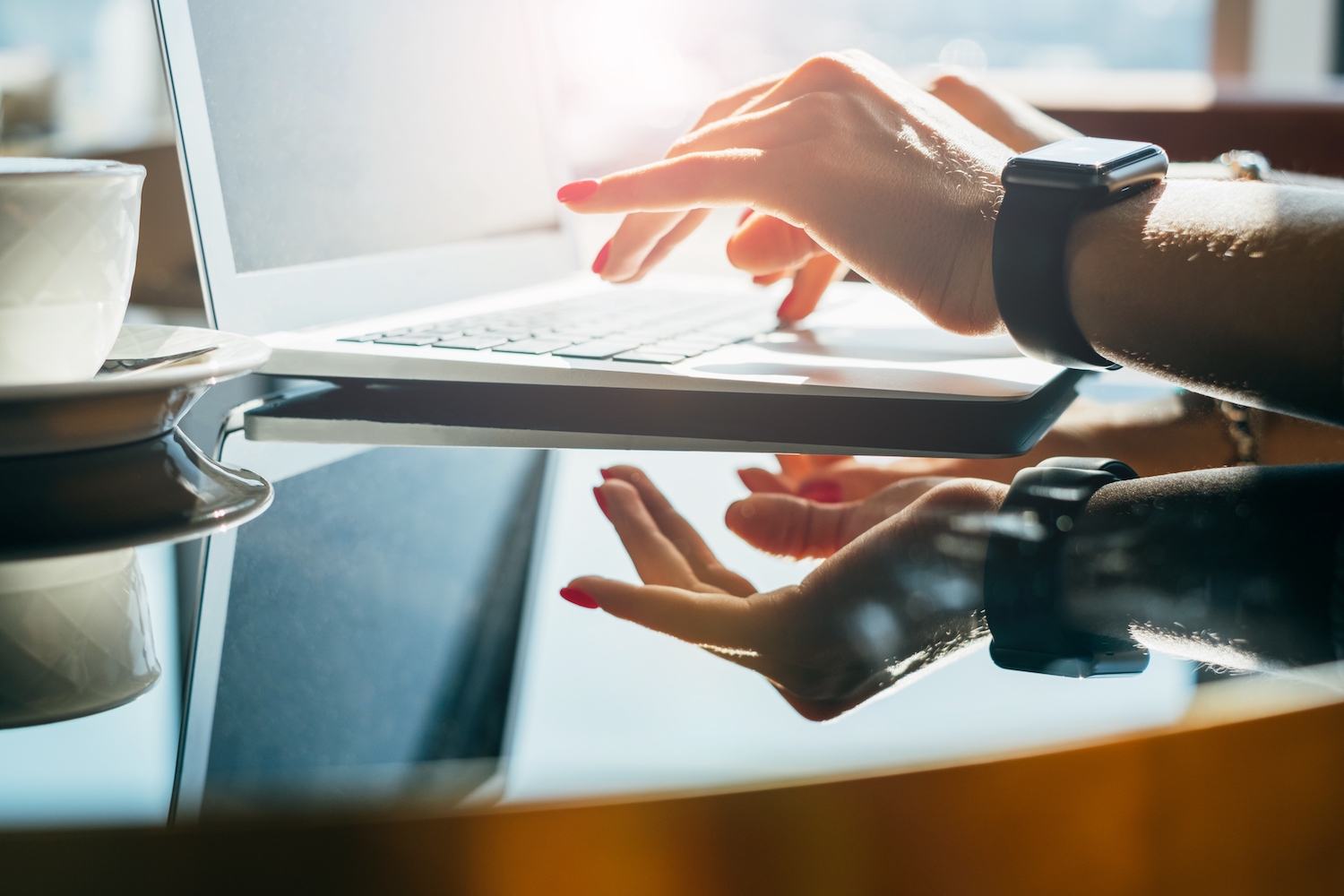 Woman's typing wearing apple watch