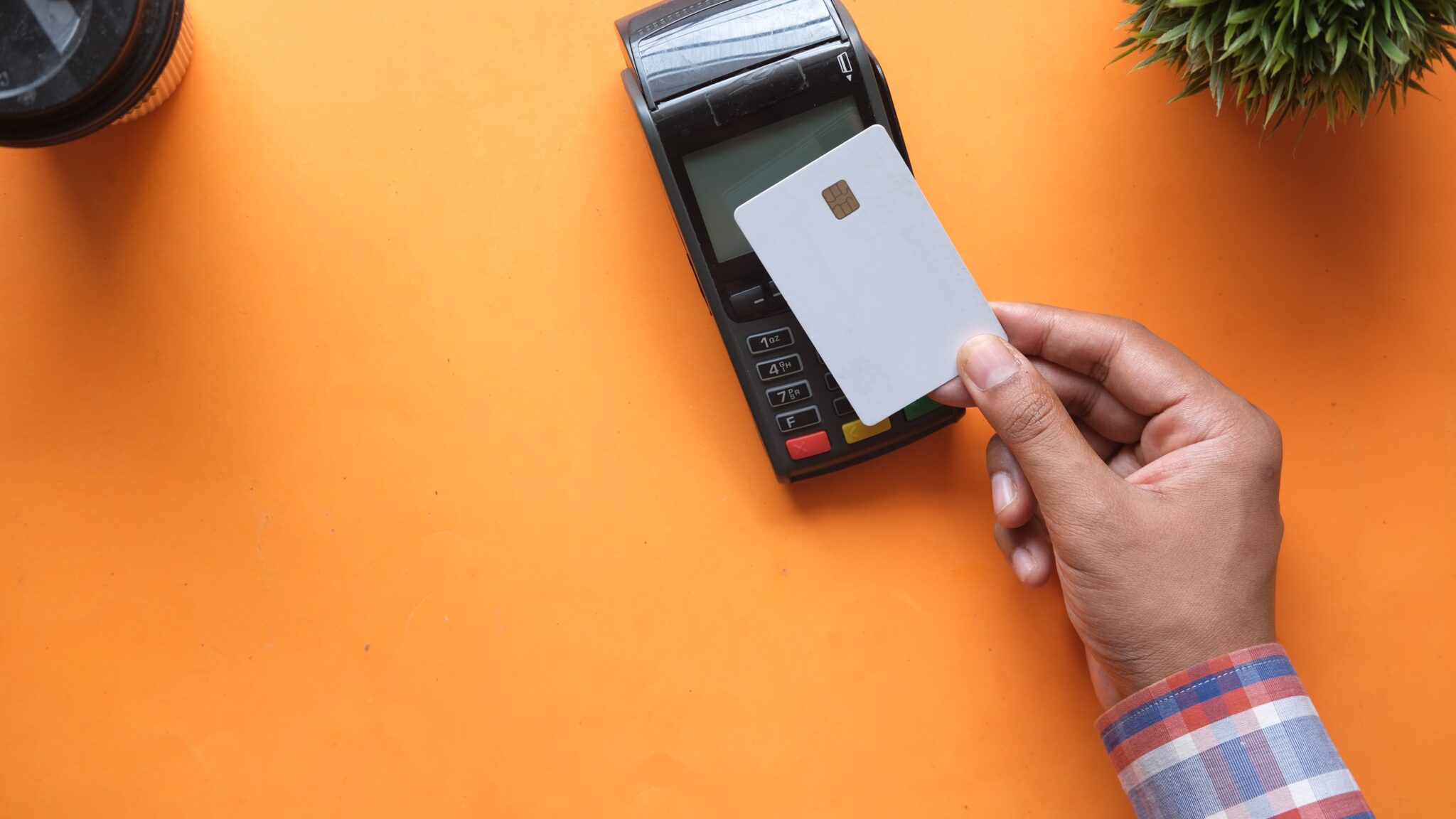 hand using credit card to make a purchase